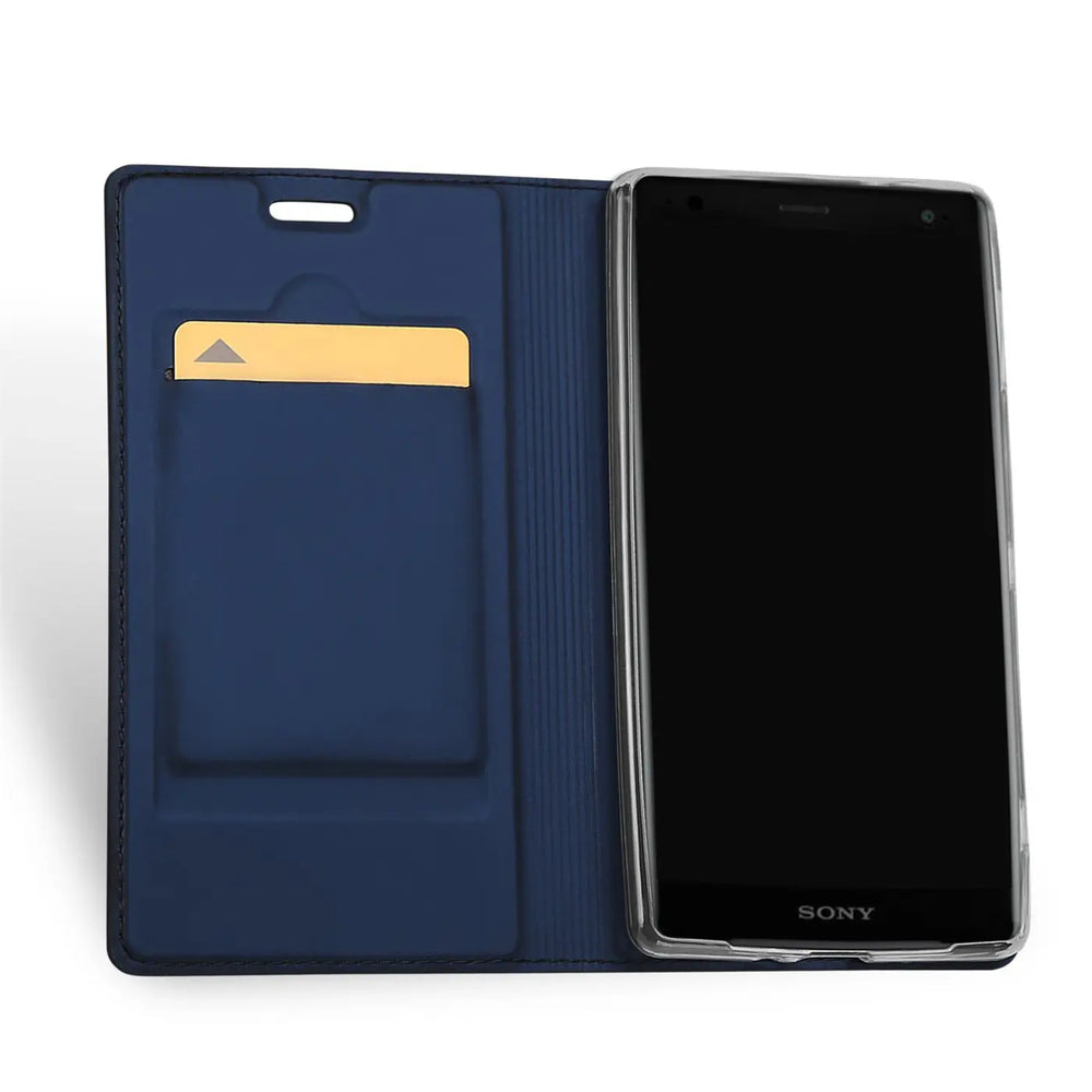 Offene, dunkelblaue Kunstleder-Flip-Hülle für Sony Xperia XZ2 Compact, mit goldener Karte in einem Fach. Ansicht von oben.