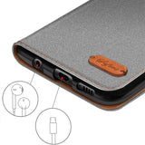 Graue Textil-Klapphülle mit braunem Lederdetail, Nahaufnahme der Anschlüsse eines Samsung Galaxy A27 5G.
